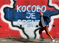 A man runs past graffiti reading 