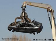 A car lifted by a crane at the scrapyard
