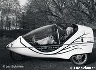 Luc Schuiten seated in his electric-powered car