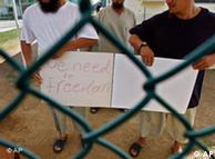 Chinese Uighur Guantanamo detainees,  show a home-made note to visiting members of the media