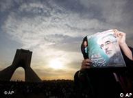 demonstrator holds up a poster of opposition leader Mousavi