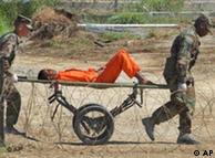 A detainee on a stretcher in Guantanamo prison camp