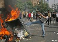 Protestor in Tehran sets fire to a barricade