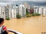 A woman looks at flood waters in Liuzhou in south China's Guangx region 