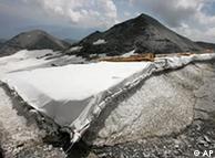 A white fleece is rolled out on the ski slopes on the Vorab glacier in Switzerland