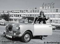 Aenne Burda getting into a car in front of her publishing house