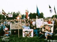 Protesters along the human chain hold signs criticizing the Soviet regime in 1989