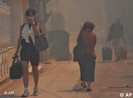 People walking through smoke-filled streets
