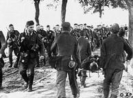 German troops march past Polish prisoners of war during World War II