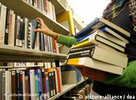 A student takes books of shelves in the Wuerzburg University library