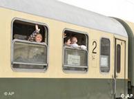 People wave from a train