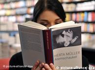 A woman reads a book by Herta Mueller