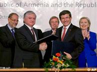 Armenian foreign minister Edouard Nalbandian and Turkish foreign minister Ahmet Davutoglu shake hands while European Union foreign affairs chief Javier Solana, French foreign minister Bernard Kouchner, and US Secretary of State Hillary Rodham Clinton applaude during the signing ceremony between Armenia and Turkey in Zurich in 2009 