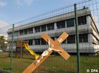 A crucifix haning on the fence outside an Italian school