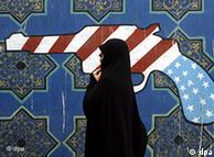 An Iranian woman walk past a mural outside former US embassy during during a demonstration marking the 30th anniversary of US Embassy takeover on 4 November 2009 in front of the former US embassy in Tehran , Iran.