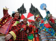 Revellers celebrate Carnival in front of Cologne Cathedral