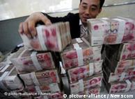 Man stakcing yuan banknotes