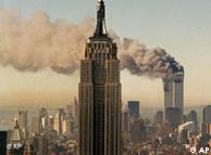 Smoke pours from one of the twin towers into the New York sky. Empire State Building in the foreground