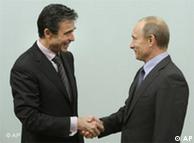 NATO chief and Russian Prime Minister Vladimir Putin shaking hands