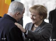 Merkel greets Netanyahu, puts hand on his shoulder  