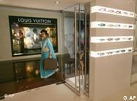 An Indian woman walks past a designer boutique 