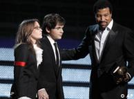 Michael Jackson's children Paris, left, and Prince Michael Jackson II accept the  Lifetime Achievement award on behalf their father presented by Lionel Richie, right, at the Grammy Awards on Sunday, Jan. 31, 2010, in Los Angeles. (AP Photo/Matt Sayles)