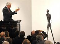Auctioneer Henry Wyndam sells the sculpture 'Walking Man I' or 'L'Homme qui marche I', by Alberto Giacometti, at Sotheby's auction rooms in London, Feb. 3, 2010