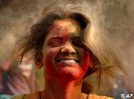 An Indian girl enjoys color powder being thrown at her in Bhubaneswar in the eastern state of Orissa