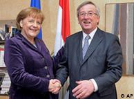 Germany's Chancellor Angela Merkel, left, smiles as she's shakes hands with Luxembourg's Prime Minister Jean Claude Juncker in his office at the State Ministry in Luxembourg, Tuesday March 9, 2009. Merkel is on a one-day working visit in Luxembourg. (AP Photo/Nicolas Bouvy, Pool)