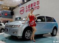 A model poses next to a new BYD e6 electric vehicle of Chinese automaker BYD Auto at the Shanghai International Auto Show 