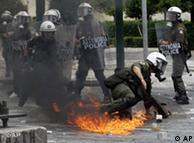 A fire bomb thrown by protesters burns in central Athens
