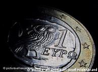 A euro coin covered in shadow