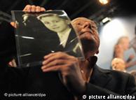 A man holds the photo of a priest abuse victim