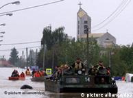 Rescue workers on a boat on a flooded street