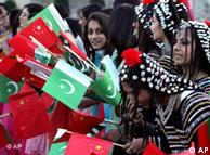 Pakistani girls wave Chinese and Pakistani flags