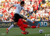 Germany's Mesut Oezil, front, fires a shot 