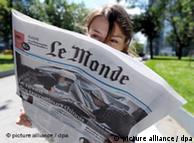 A woman reads Le Monde