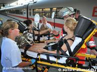 A girl is taken off a train on a stretcher