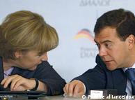 Merkel and Medvedev chatting at Petersburg Dialogue