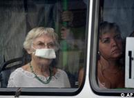 Riding in a bus a woman wears a mask protecting her from a thick blanket of smog covering Moscow