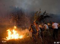 Local citizens attempt to extinguish a forest fire near the Russian village of Dolginino