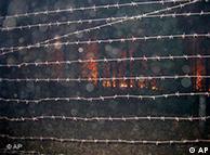 An approaching forest fire seen through the barbed wire fence of Russia's top nuclear facility, Sarov