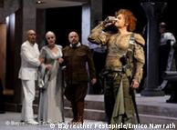 Four actors stand on stage with Lance Ryan in costume as Siegfried on the far right
