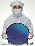 Man holding a disc of silicon