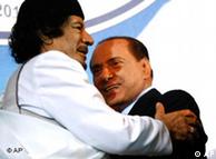 Gadhafi embracing Berlusconi