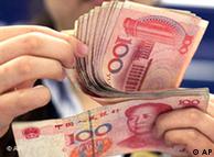 Hands with wads of yuan notes