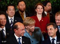 Chancellor Angela Merkel speaking to French President Nicolas Sarkozy at the ASEM summit
