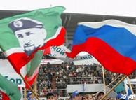 Young Chechens wave Russian flags and flags of Chechnya 