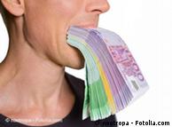 Person biting on a pack of euro currency notes