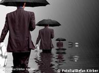 Men in suits holding umbrellas as they wade into deeper water